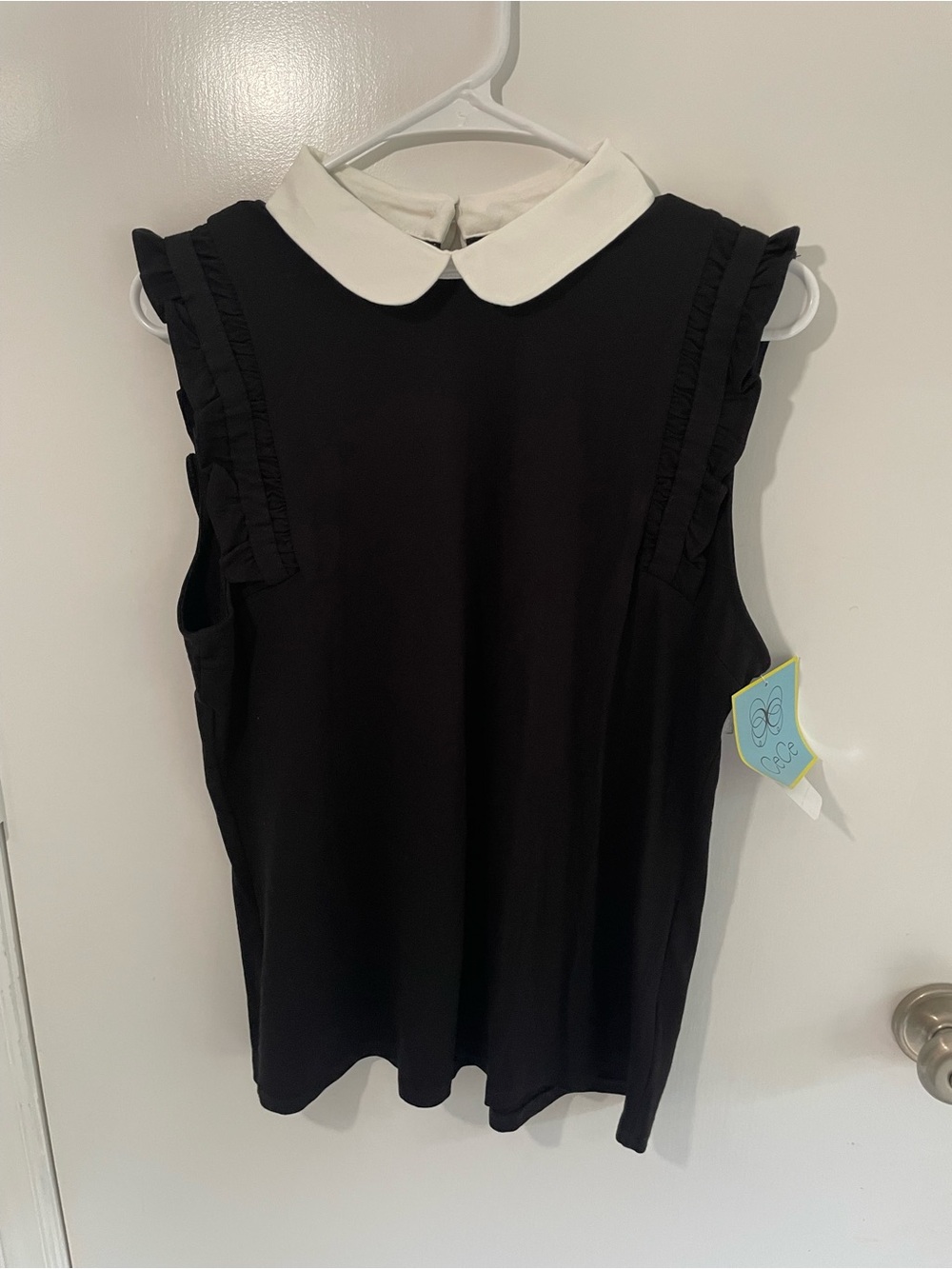 CeCe Black Sleeveless Top with White Peter Pan Collar. Feminine, layering piece.